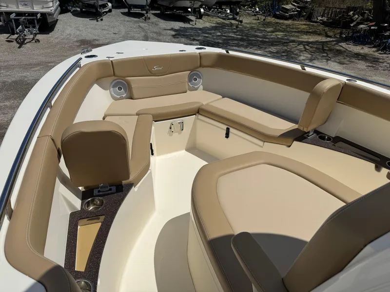 Slide: The Image of 2019 Scout 235 XSF boat interior with beige seating and cup holders. - 15