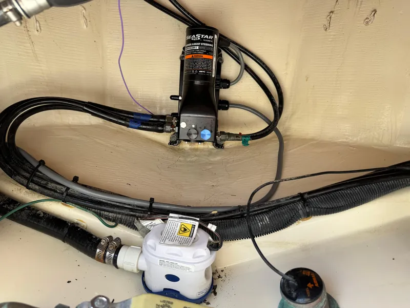 Slide: The Image of 2019 Scout 235 XSF boat interior showing wiring and pump system. - 27