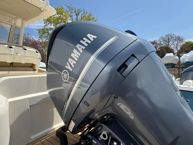 Slide: The Image of 2019 Scout 235 XSF boat with Yamaha outboard motor, docked under clear sky. - 30
