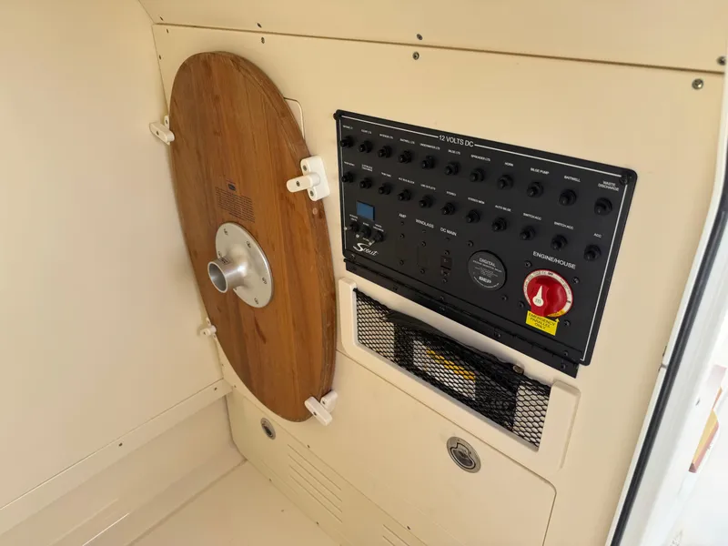 Slide: The Image of 2019 Scout 235 XSF control panel with wooden cover and switches. - 34