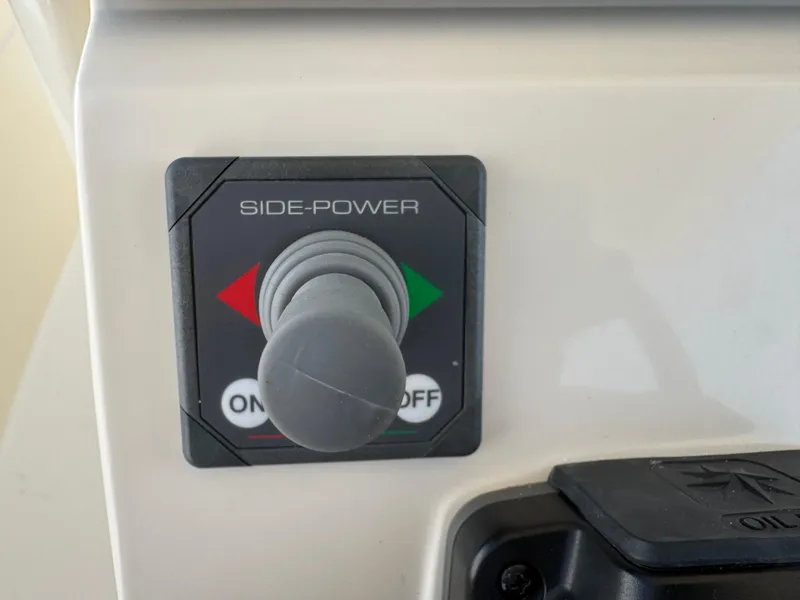 Slide: The Image of Side-Power control panel on 2019 Scout 235 XSF boat, featuring joystick and on/off buttons. - 37