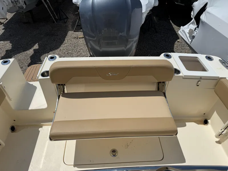 Slide: The Image of 2019 Scout 235 XSF boat with tan seating and storage compartment. - 39