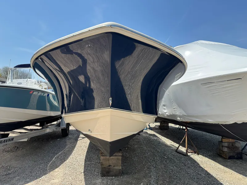 Slide: The Image of 2019 Scout 235 XSF boat on display, front view, parked on gravel. - 4