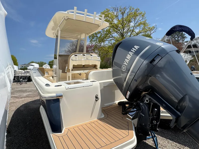 Slide: The Image of 2019 Scout 235 XSF boat with Yamaha outboard motor, docked outdoors. - 47