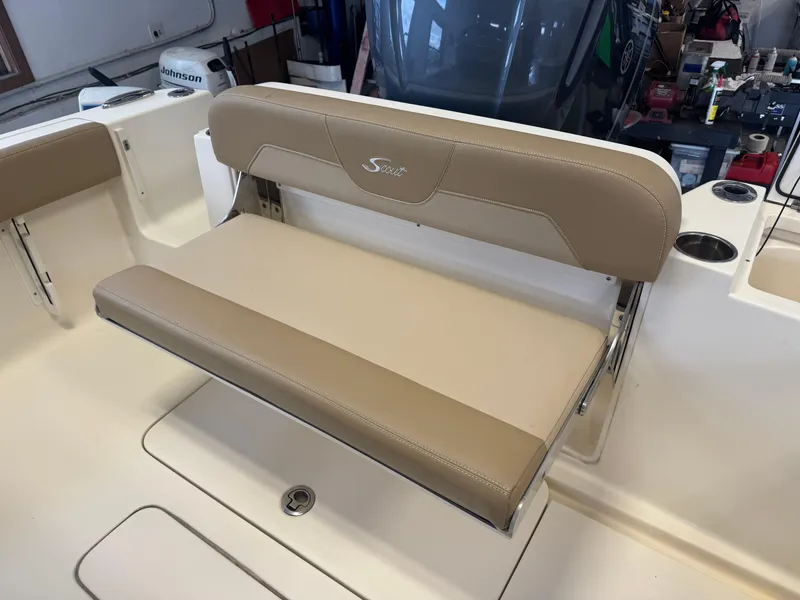 Slide: The Image of 2019 Scout 235 XSF boat seat with beige upholstery in a garage setting. - 48
