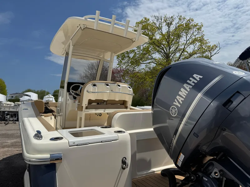 Slide: The Image of 2019 Scout 235 XSF boat with Yamaha engine, docked outdoors under a clear sky. - 8