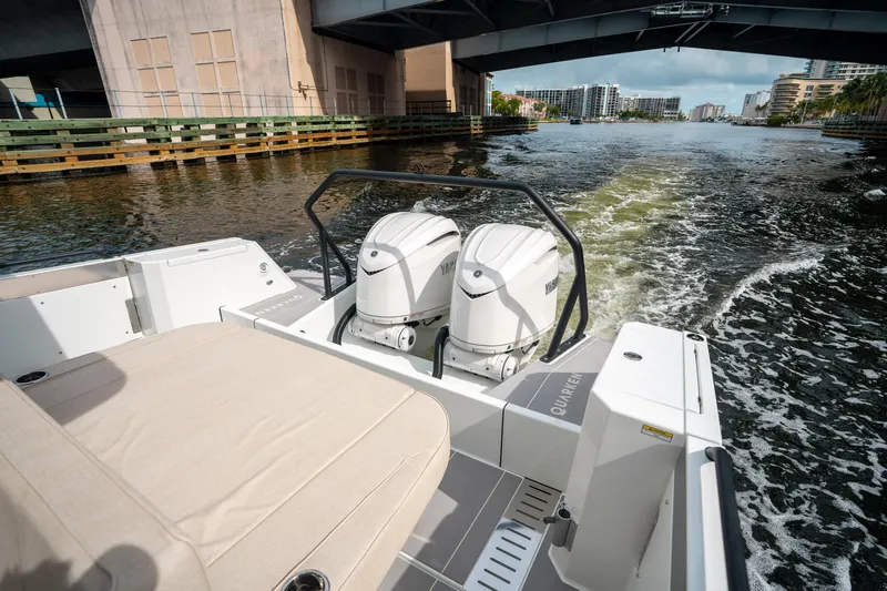 Slide: The Image of 2025 Quarken 35 Sport Tourer cruising under a bridge, showcasing dual outboard engines. - 11