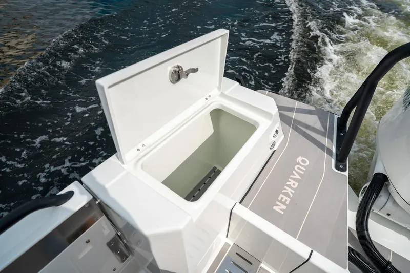 Slide: The Image of 2025 Quarken 35 Sport Tourer boat with open storage compartment on deck. - 18