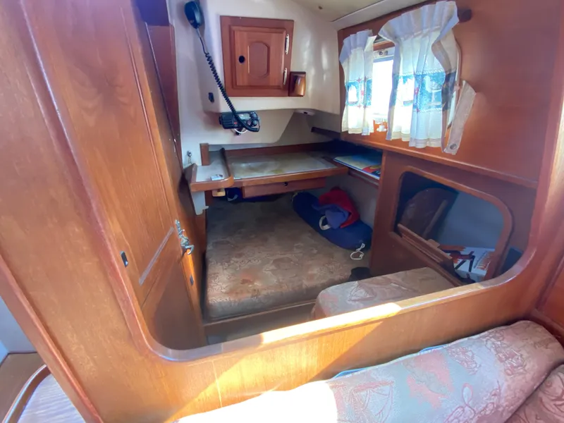 Slide: The Image of Cozy interior of a 1991 Newport 31 sailboat with wooden furnishings and nautical decor. - 17
