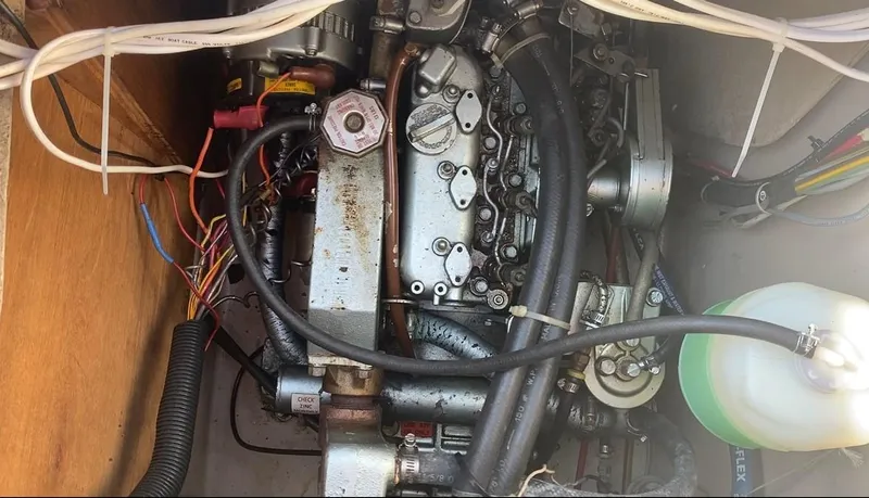 Slide: The Image of Engine compartment of a 1991 Newport 31 sailboat, showing wiring and mechanical components. - 18