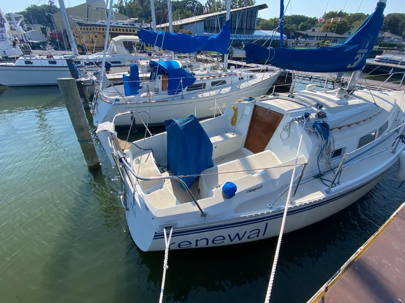 Slide: The Image of Sailboat Newport 31, 1991 model, docked at marina with blue covers. - 3