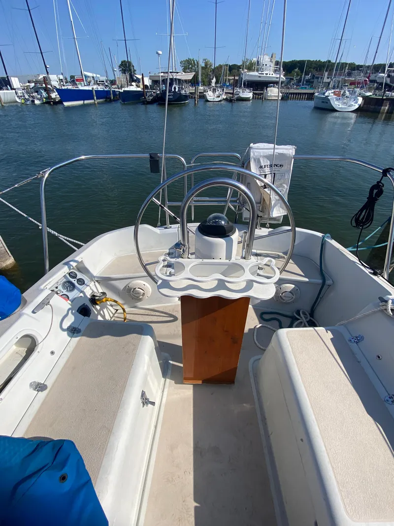 Slide: The Image of Cockpit of a 1991 Newport 31 sailboat docked in a marina. - 4