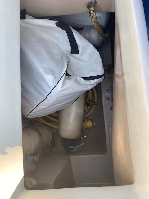 Slide: The Image of Storage compartment of a 1991 Newport 31 boat with equipment and gear. - 6