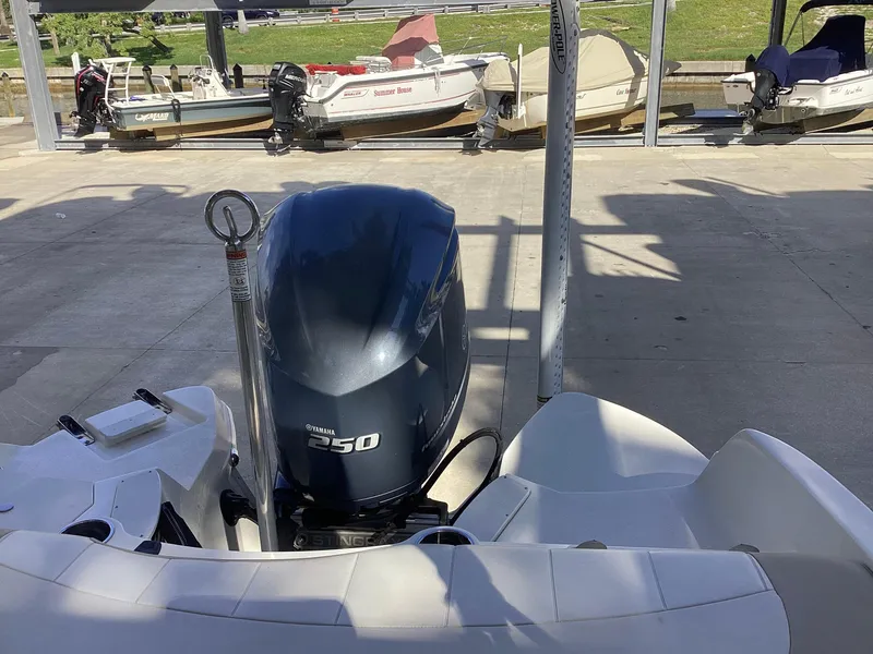 Slide: The Image of 2017 Stingray 234 LR boat with Yamaha 250 engine, docked in marina. - 12