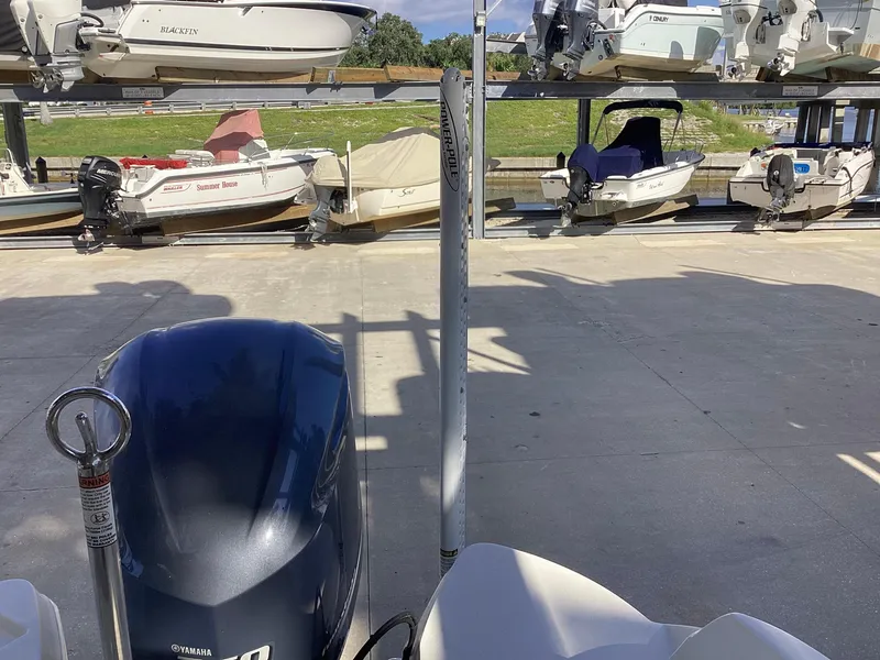Slide: The Image of 2017 Stingray 234 LR boat in storage facility with other boats. - 14