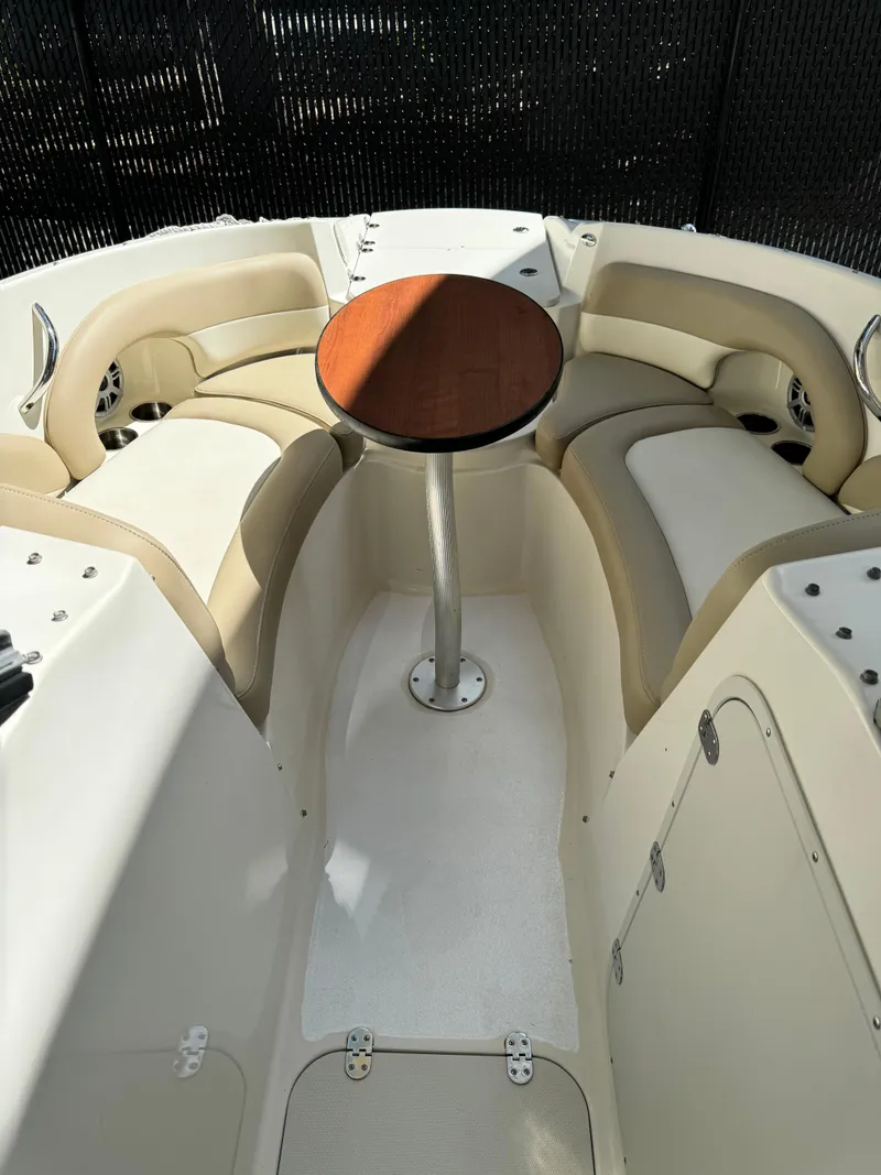 Slide: The Image of 2017 Stingray 234 LR boat interior with seating and table. - 16