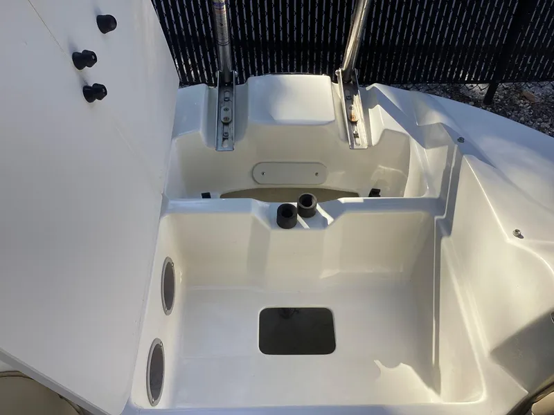 Slide: The Image of 2017 Stingray 234 LR boat interior with storage compartments and seating area. - 17