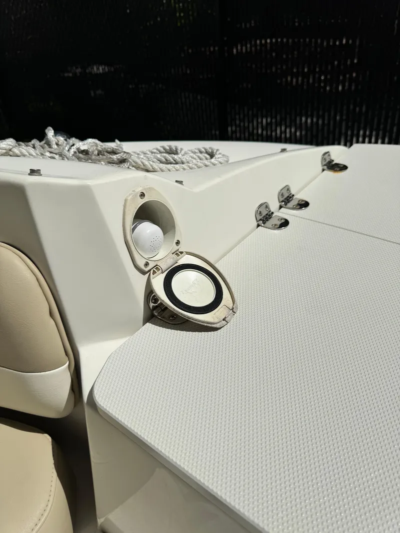 Slide: The Image of 2017 Stingray 234 LR boat deck with rope and open hatch. - 18