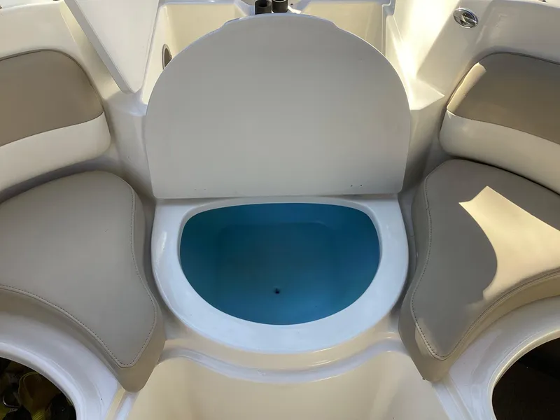 Slide: The Image of 2017 Stingray 234 LR boat interior with seating and storage compartment. - 19