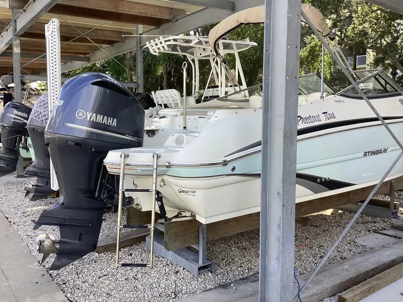 Slide: The Image of 2017 Stingray 234 LR boat with Yamaha outboard motor in storage. - 2