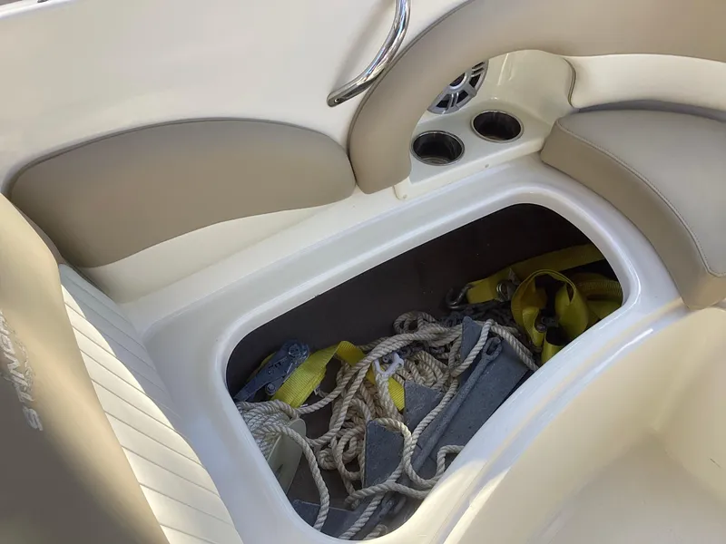 Slide: The Image of 2017 Stingray 234 LR boat interior storage with ropes and accessories. - 21