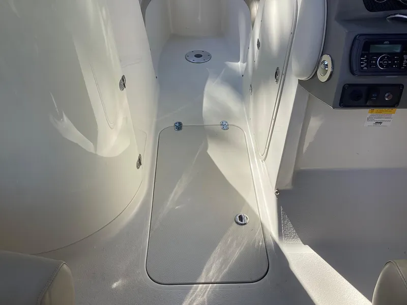 Slide: The Image of Interior view of 2017 Stingray 234 LR boat, featuring sleek white design and control panel. - 26
