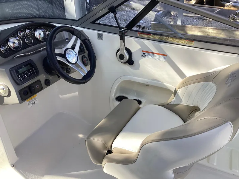 Slide: The Image of 2017 Stingray 234 LR boat cockpit with steering wheel and comfortable seating. - 30