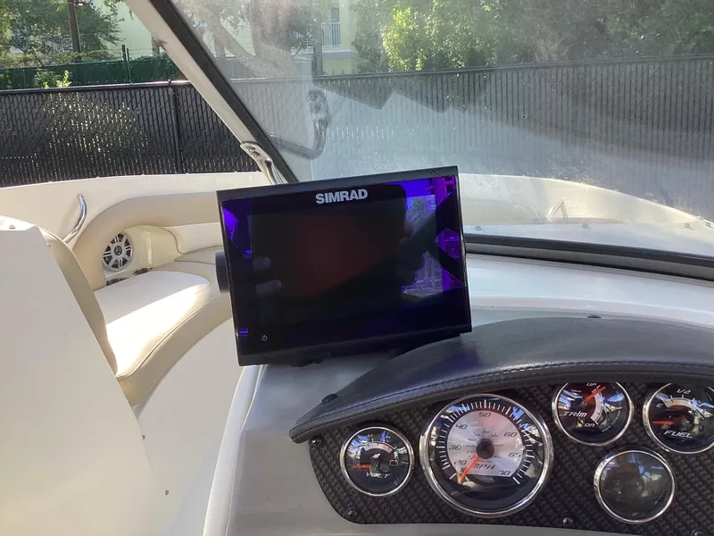 Slide: The Image of Simrad display and gauges on 2017 Stingray 234 LR boat dashboard. - 31