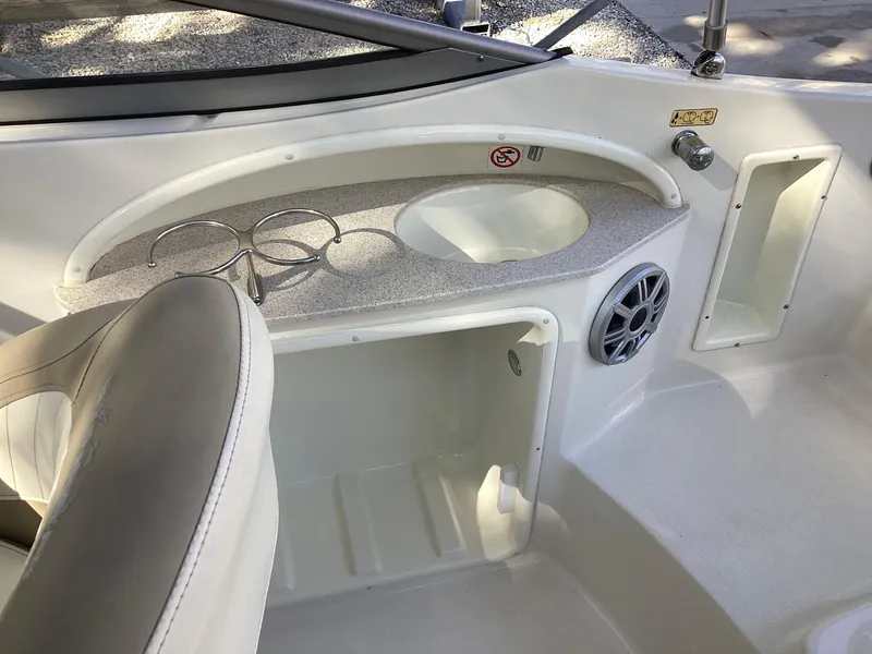 Slide: The Image of 2017 Stingray 234 LR boat interior with cup holders and speaker. - 35