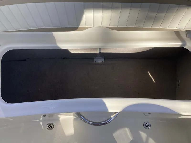 Slide: The Image of Open storage compartment in 2017 Stingray 234 LR boat. - 36