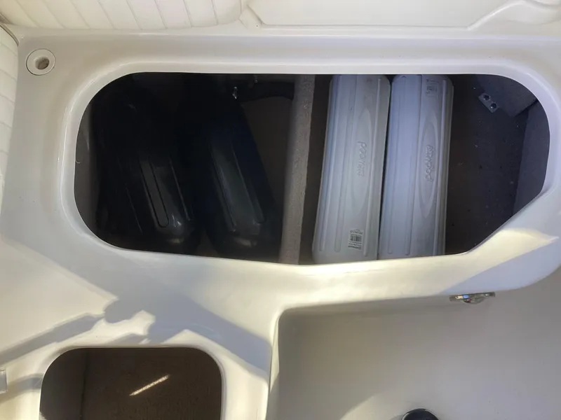 Slide: The Image of 2017 Stingray 234 LR boat storage compartment with equipment. - 37