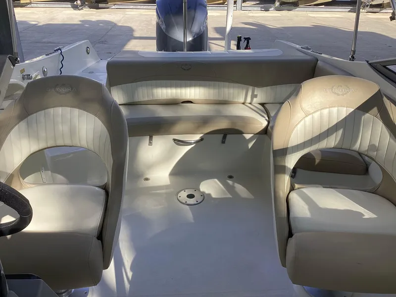 Slide: The Image of 2017 Stingray 234 LR boat interior with beige seating and spacious layout. - 40