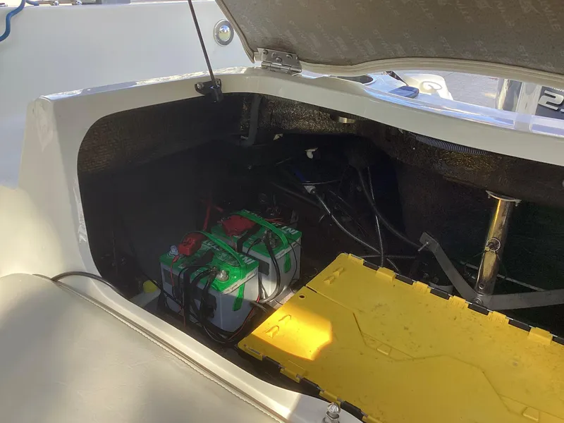 Slide: The Image of Open engine compartment of 2017 Stingray 234 LR boat showing batteries and wiring. - 41