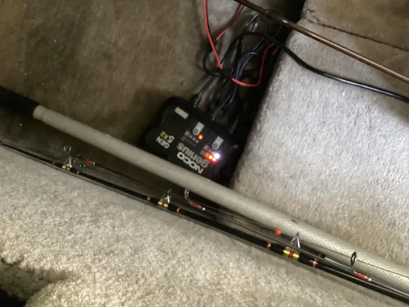 Slide: The Image of 2017 Stingray 234 LR boat interior with wiring and fishing rods. - 42