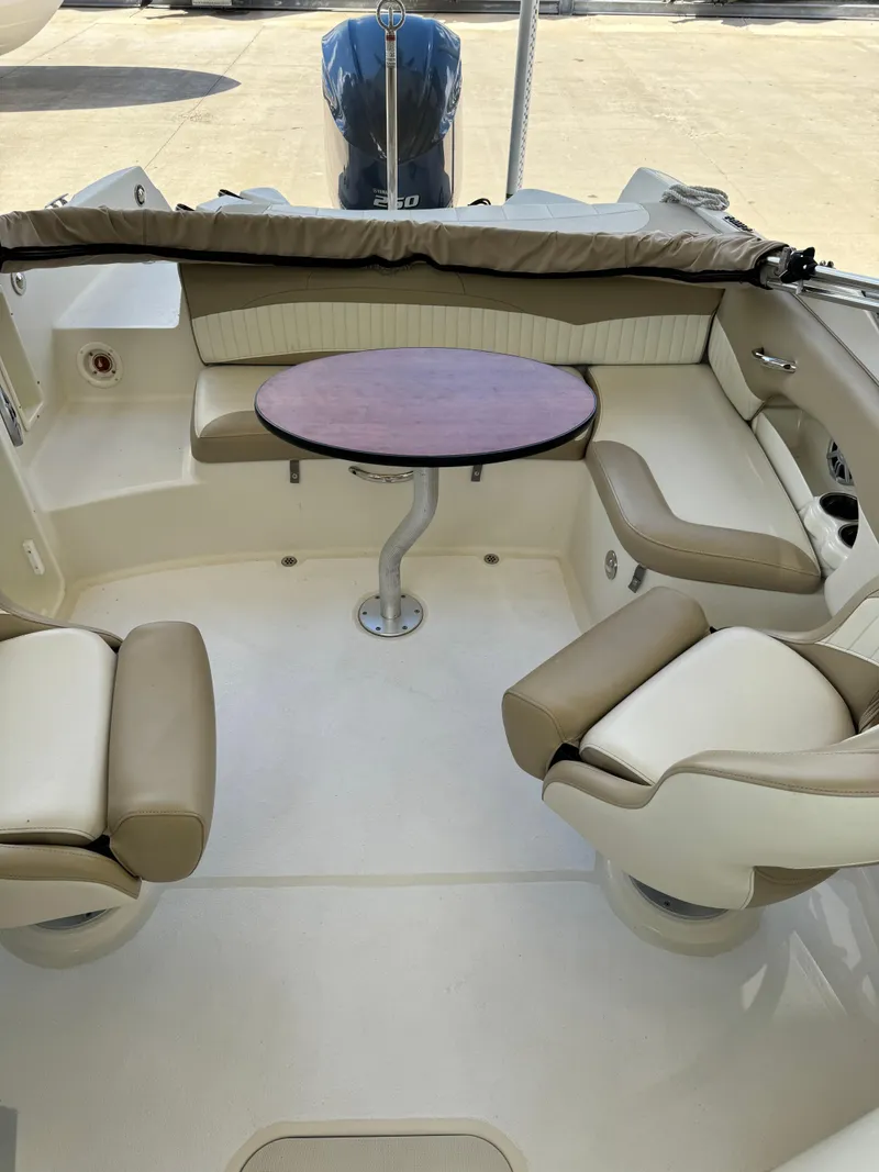 Slide: The Image of 2017 Stingray 234 LR boat interior with seating and table. - 45
