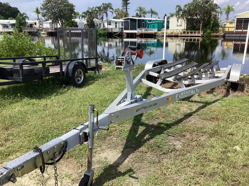 Slide: The Image of Boat trailer near waterfront, grassy area, Stingray 234 LR, 2017 model. - 47