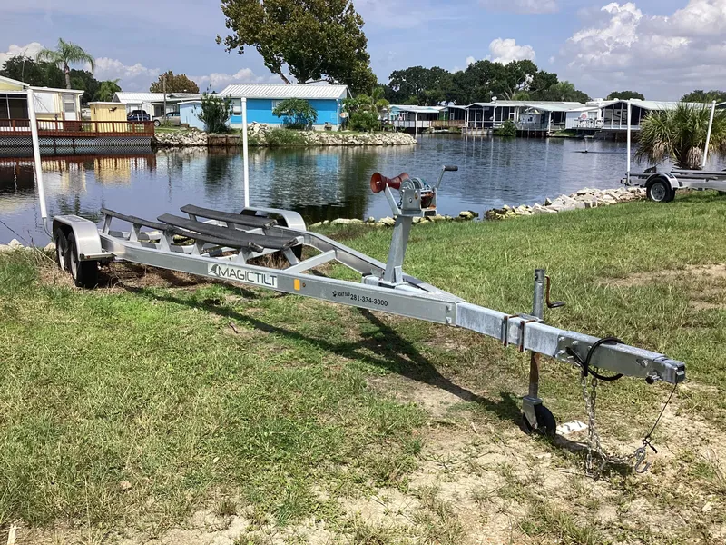 Slide: The Image of Boat trailer near a lake, suitable for 2017 Stingray 234 LR model. - 48