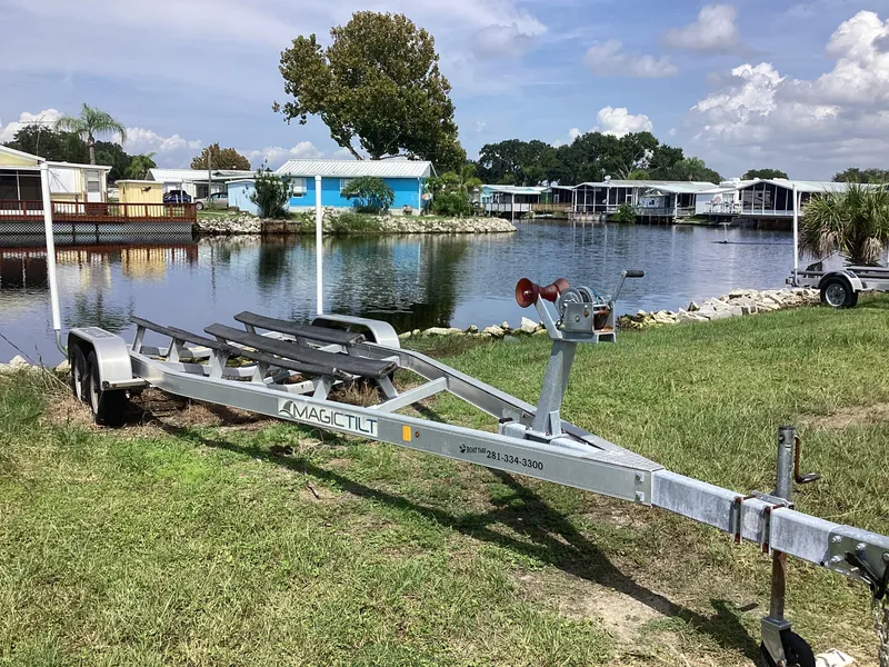 Slide: The Image of Boat trailer near waterfront homes, grassy area; Stingray 234 LR, 2017 model. - 49