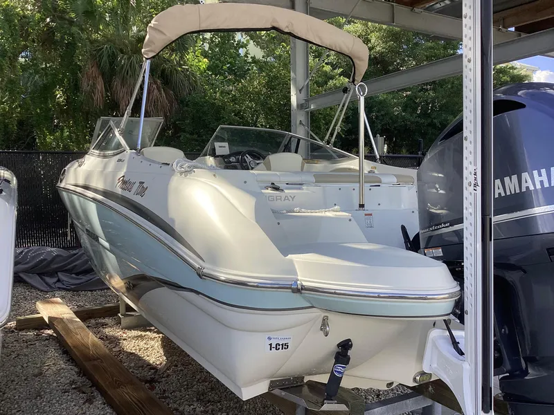 Slide: The Image of 2017 Stingray 234 LR boat with Yamaha engine, docked under shelter. - 5