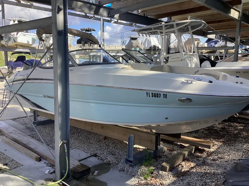 Slide: The Image of 2017 Stingray 234 LR boat in storage, surrounded by other vessels. - 7