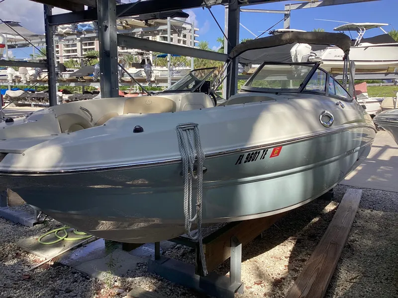 Slide: The Image of 2017 Stingray 234 LR boat in dry dock, surrounded by other vessels. - 8