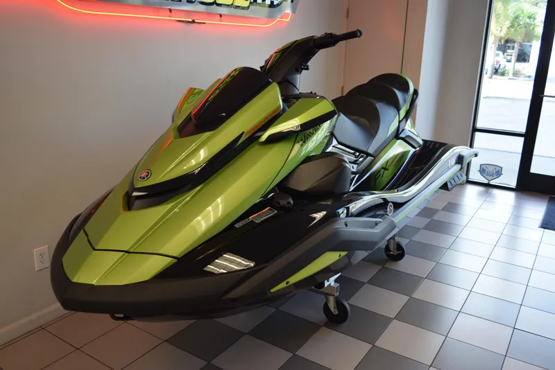 Slide: The Image of 2024 Yamaha WaveRunner FX Cruiser SVHO in showroom, vibrant green and black design. - 2