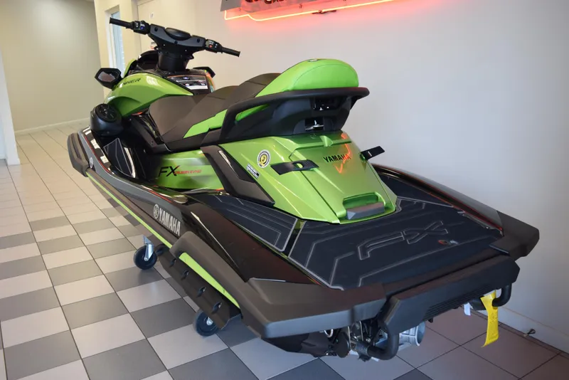 Slide: The Image of 2024 Yamaha WaveRunner FX Cruiser SVHO in vibrant green, displayed indoors. - 4