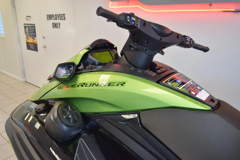 Slide: The Image of 2024 Yamaha WaveRunner FX Cruiser SVHO in showroom, green and black design. - 7