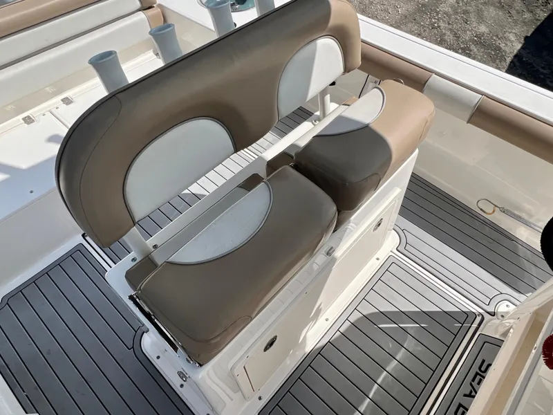 Slide: The Image of 2021 Sea Born LX24 boat interior with cushioned seating and rod holders. - 11