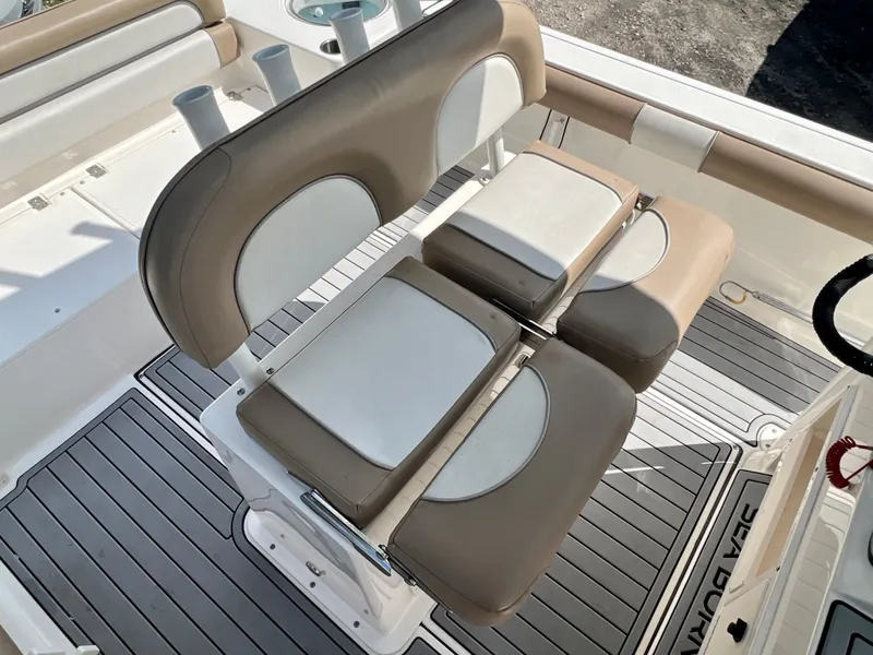 Slide: The Image of 2021 Sea Born LX24 boat seating with tan and white cushions. - 12