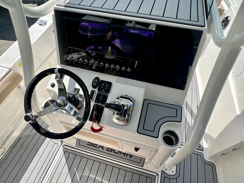 Slide: The Image of 2021 Sea Born LX24 boat dashboard with steering wheel and controls. - 14