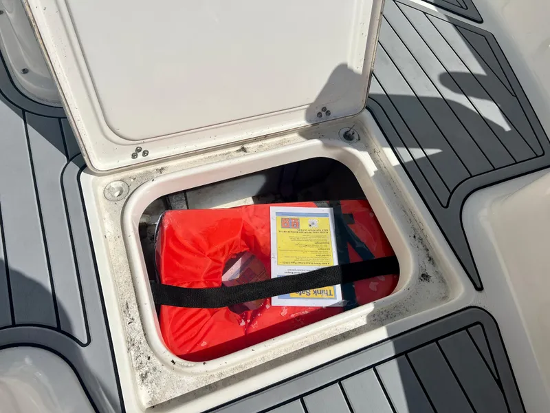 Slide: The Image of 2021 Sea Born LX24 boat storage compartment with life jacket and safety instructions. - 26