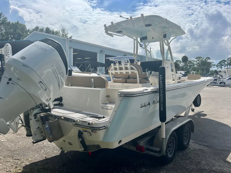 Slide: The Image of 2021 Sea Born LX24 boat on trailer, parked outdoors under cloudy sky. - 7