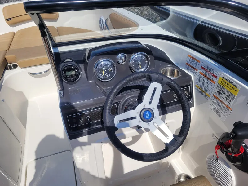 Slide: The Image of 2025 Bayliner VR4 Bowrider OB dashboard with steering wheel and gauges. - 12